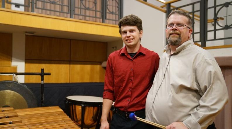 大卫•沃克, left, is director of percussion studies at bet8体育娱乐入口. 在这里, he poses on stage at Chandler Recital Hall with his 儿子 Michael, 他是一名打击乐手，也是ODU的学生.